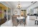 The dining room features an attractive chandelier, seating for six, and access to the lanai and kitchen at 11763 Eagle Ray Ln, Orlando, FL 32827