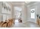 Elegant foyer with tile flooring, a decorative mirror, and an open view into the music room at 11763 Eagle Ray Ln, Orlando, FL 32827