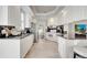 A well-lit kitchen with tile floors, white cabinets, granite countertops and updated stainless-steel appliances at 11763 Eagle Ray Ln, Orlando, FL 32827