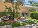 Well-manicured landscaping featuring various plants, colorful flowers, decorative rocks, and lush green grass at 11763 Eagle Ray Ln, Orlando, FL 32827