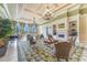 Spacious lounge area with a fireplace, grand chandeliers, and elegant furnishings, perfect for relaxation at 11763 Eagle Ray Ln, Orlando, FL 32827