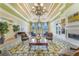 Comfortable lounge area with a chandelier, fireplace, and comfortable seating at 11763 Eagle Ray Ln, Orlando, FL 32827