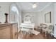 Elegant music room showcasing a white grand piano, plantation shutters, and stylish seating at 11763 Eagle Ray Ln, Orlando, FL 32827