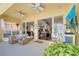 Relaxing covered patio with comfortable seating, ceiling fans, and access to indoor living spaces at 11763 Eagle Ray Ln, Orlando, FL 32827
