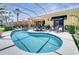 Gorgeous kidney-shaped pool surrounded by lush landscaping and ample space for lounging and entertaining at 11763 Eagle Ray Ln, Orlando, FL 32827