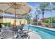Charming poolside dining area for enjoying meals and gatherings in a serene outdoor setting at 11763 Eagle Ray Ln, Orlando, FL 32827
