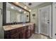 Elegant bathroom with a double sink vanity, granite countertop, and decorative pendant lights at 1304 Deer Run Dr, Winter Springs, FL 32708