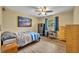 Bedroom with light-colored walls, a bed, desk, chest of drawers, and a ceiling fan at 1304 Deer Run Dr, Winter Springs, FL 32708