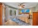 Comfortable bedroom featuring a large bed, wood floors, outdoor access and stylish accents at 1304 Deer Run Dr, Winter Springs, FL 32708