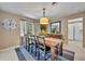 Cozy dining room with wood table, seating for six, pendant lighting, and a charming window view at 1304 Deer Run Dr, Winter Springs, FL 32708