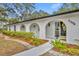 A lovely house with an arched entryway and garden beds at 1304 Deer Run Dr, Winter Springs, FL 32708