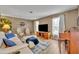Spacious living room featuring modern seating, a large TV, and an aviation-themed decor at 1304 Deer Run Dr, Winter Springs, FL 32708