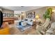 Bright and airy living room with light wood floors, neutral walls, comfortable seating, and aviation decor at 1304 Deer Run Dr, Winter Springs, FL 32708
