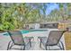 Relaxing poolside with lounge chairs overlooking the pool and lush yard at 1304 Deer Run Dr, Winter Springs, FL 32708
