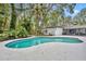 A private backyard oasis with a pool and mature landscaping at 1304 Deer Run Dr, Winter Springs, FL 32708
