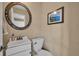 This powder room has a stylish mirror, a new sink, and a modern toilet at 1304 Deer Run Dr, Winter Springs, FL 32708