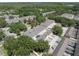 Aerial view showcasing townhomes surrounded by beautiful trees and landscaping, enhancing the neighborhood's appeal at 14242 Avenue Of The Groves, Winter Garden, FL 34787