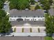 Stunning aerial view showcasing townhome garages with brick-paver driveways and a screened-in back patio at 14242 Avenue Of The Groves, Winter Garden, FL 34787