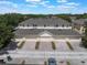 Stunning aerial view showcasing townhome garages with brick-paver driveways and a desirable community at 14242 Avenue Of The Groves, Winter Garden, FL 34787