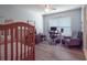 Bright bedroom featuring a crib and desk at 14242 Avenue Of The Groves, Winter Garden, FL 34787