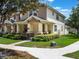 Beautiful two-story home with a welcoming porch, manicured lawn, and lush greenery at 14242 Avenue Of The Groves, Winter Garden, FL 34787
