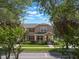 Charming two-story home with a well-maintained lawn and lush landscaping in a desirable neighborhood at 14242 Avenue Of The Groves, Winter Garden, FL 34787