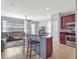 Open-concept kitchen with stainless steel appliances overlooks the cozy living room area at 14242 Avenue Of The Groves, Winter Garden, FL 34787