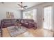 Comfortable living room with plush sectional sofa, ceiling fan, and a view of the outdoor patio at 14242 Avenue Of The Groves, Winter Garden, FL 34787