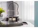 Modern kitchen sink with a pull-down faucet and a granite countertop at 14242 Avenue Of The Groves, Winter Garden, FL 34787