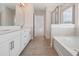 Bathroom with a tiled floor, soaking tub and shower with glass doors at 16195 Point Rock Dr, Winter Garden, FL 34787