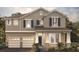 Charming two-story home featuring a 2-car garage, neutral siding, and inviting curb appeal at 16195 Point Rock Dr, Winter Garden, FL 34787