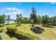 Aerial view of backyard featuring grill, storage shed, and manicured lawn at 16692 Lake Pickett Rd, Orlando, FL 32820