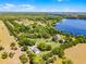 Idyllic estate with mature trees, rolling fields, and serene lake views at 16692 Lake Pickett Rd, Orlando, FL 32820