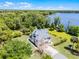 Stunning lakefront home with lush landscaping, private dock, and desirable curb appeal at 16692 Lake Pickett Rd, Orlando, FL 32820