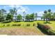 An expansive backyard featuring lush lawn, mature trees, and lovely lake views at 16692 Lake Pickett Rd, Orlando, FL 32820