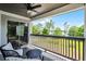 Relaxing balcony featuring outdoor seating and a ceiling fan overlooking serene water and nature views at 16692 Lake Pickett Rd, Orlando, FL 32820