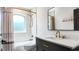 Modern bathroom featuring stylish vanity with marble countertop, bronze fixtures, and shower with decorative curtain at 16692 Lake Pickett Rd, Orlando, FL 32820