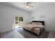 Serene bedroom featuring a comfortable bed and sliding glass door with backyard views at 16692 Lake Pickett Rd, Orlando, FL 32820