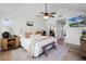 Bright bedroom with a vaulted ceiling, ceiling fan and hardwood floors, creating a cozy and inviting space at 16692 Lake Pickett Rd, Orlando, FL 32820