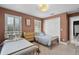 Bedroom with twin beds, woven dresser and closet featuring views from window with shutters at 16692 Lake Pickett Rd, Orlando, FL 32820