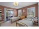 Bedroom with twin beds and view of the balcony overlooking the backyard and lake at 16692 Lake Pickett Rd, Orlando, FL 32820