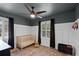 Bedroom with a neutral color palette, featuring white wainscoting and a modern ceiling fan at 16692 Lake Pickett Rd, Orlando, FL 32820