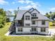 Stately two-story home boasts an outdoor balcony, lush lawn, and tranquil lake views at 16692 Lake Pickett Rd, Orlando, FL 32820