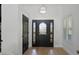 Bright foyer with light hardwood floors, a decorative front door, and white trim at 16692 Lake Pickett Rd, Orlando, FL 32820