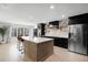 Modern kitchen features a large center island, stainless steel appliances, and ample counter space at 16692 Lake Pickett Rd, Orlando, FL 32820