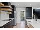 Modern kitchen boasts sleek black cabinetry, stainless steel appliances, and elegant white countertops at 16692 Lake Pickett Rd, Orlando, FL 32820