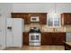 Close-up of kitchen featuring stainless steel appliances, updated cabinetry, and tile backsplash at 16692 Lake Pickett Rd, Orlando, FL 32820