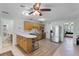 Spacious kitchen with stainless steel appliances, eat-in counter, and a ceiling fan at 16692 Lake Pickett Rd, Orlando, FL 32820
