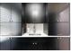 Well-organized laundry room features dark cabinets, a sink, and stylish hardware at 16692 Lake Pickett Rd, Orlando, FL 32820