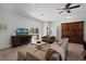 Cozy living room with plush seating, entertainment center, and sliding glass doors to the backyard at 16692 Lake Pickett Rd, Orlando, FL 32820